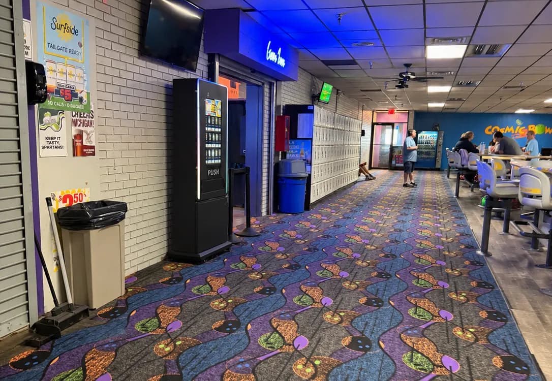 A trading-card vending machine conveniently placed near the seating area of a bowling center